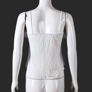 Close-up of white strapless top featuring wavy textured fabric and hollowed tie-back detail