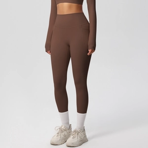 Close-up of high-waisted yoga pants featuring wide waistband and functional side pockets