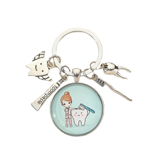Creative dental keychain set with cartoon dentist glass pendant, toothbrush, and tooth charms
