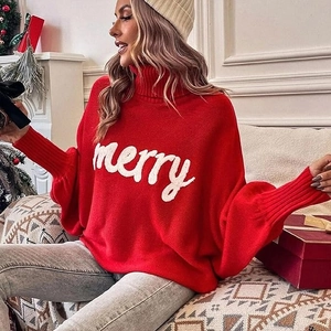 Close-up of knit texture and white merry script on a red Christmas turtleneck sweater