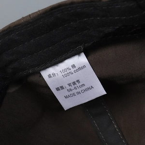 Detail of 100% cotton lining and adjustable inner strap on deep brown baseball cap