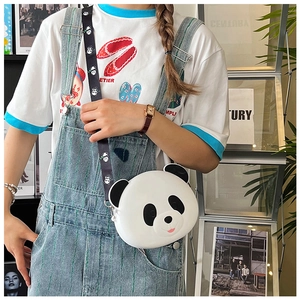 Detail of cute panda silicone crossbody bag with patterned shoulder strap on a model