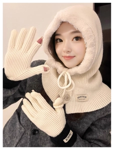 Detail of cream white winter balaclava hood and matching knitted gloves for women