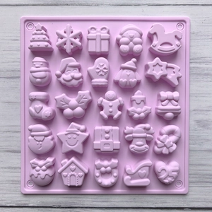 Detailed top view of a pink silicone mold with 25 unique Christmas holiday shapes