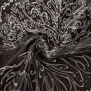 Detail of bohemian mandala tapestry featuring white floral vines on dark fabric texture