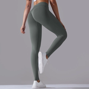 Detail view of seamless high-waisted yoga pants featuring booty lifting stitching in dark green