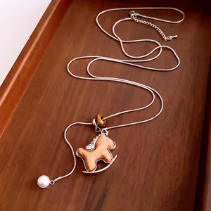 Adjustable wooden rocking horse pendant necklace with tiger eye bead on silver snake chain