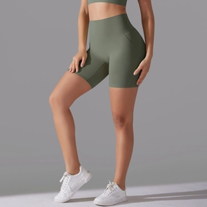Detail view of high-waist yoga shorts in sage green with ergonomic seamless stitching