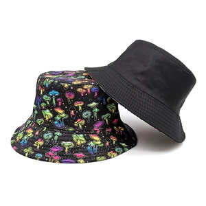 Reversible bucket hat with neon mushroom print and classic solid black cotton design
