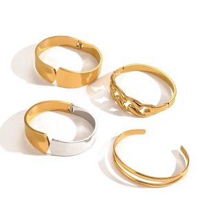 Macro shot of 18k gold plated stainless steel hollow bangles on white background