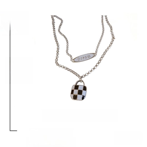 Detail view of 2-piece retro checkerboard necklace with Dream pendant in alloy material