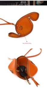 Detail view of the internal metal key ring and durable leather texture in orange