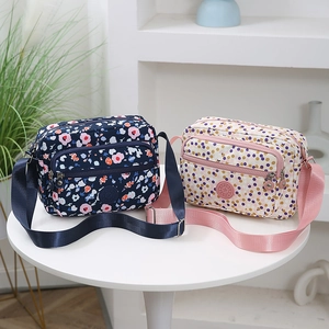 Crossbody bags with floral and polka dot prints on a table for outdoor commute