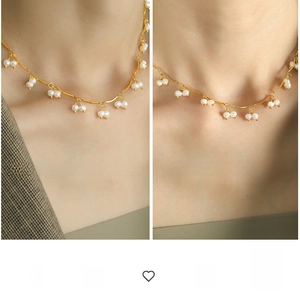 Detail showing the French style gold wavy chain necklace with small white pearl tassels
