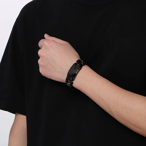 Detail of 20mm black polished stainless steel cuban chain bracelet for men on wrist