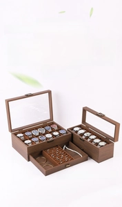 Deep walnut wood jewelry box detail with transparent glass lid and bronze metal clasp