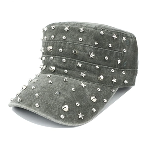 Detail view of silver metal rivets on grey denim military cap with punk style accents