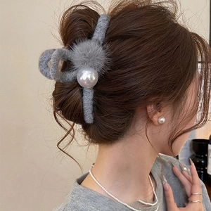 Elegant grey flocked hair claw clip with pearls shown on long brown hair from a side view