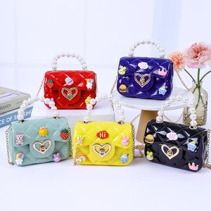 Mini pearl handle jelly handbags in five colors with cute cartoon patches and chain straps