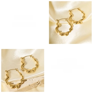 Detail of 18K gold plated stainless steel earrings with irregular organic lava texture