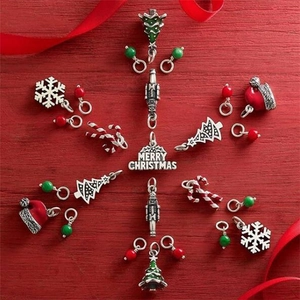 Christmas charms set with snowflakes and trees on red wood background for DIY jewelry
