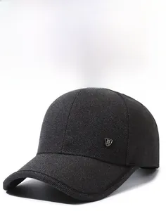 Close-up of textured black baseball cap featuring a premium metal shield M logo on the side