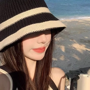 Women's knitted stripe sun hat featuring a wide brim bucket design for beach sun protection