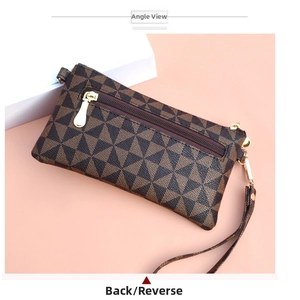 Detail view of the back side featuring geometric triangle pattern and gold zipper pocket