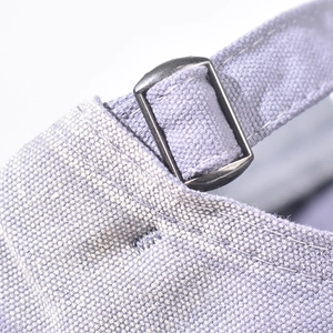 Detailed macro view of the light purple cotton fabric and adjustable metal buckle