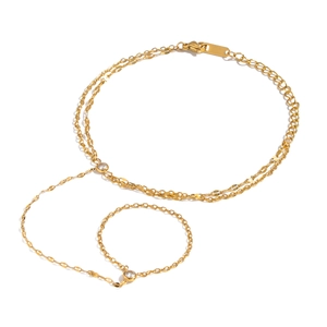 Double-layered gold stainless steel slave bracelet with zircon crystals on white background
