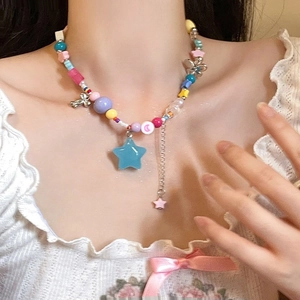 Colorful Y2K beaded necklace with blue frosted star pendant and silver charms on model