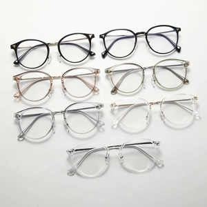 Flat lay of vintage round frame glasses in seven colors including tea and black