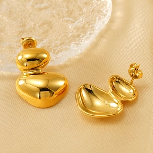 Minimalist irregular gold oval earrings with layered organic geometric design on silk