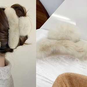 Plush beige faux rabbit fur hair claw clip for women shown on model and as a still life