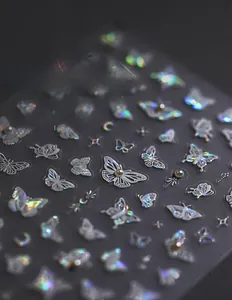 Detail of 5D aurora holographic butterfly nail stickers with pearls and starry gems