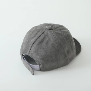 Detail view of the back of a grey baby baseball cap with an adjustable velcro strap