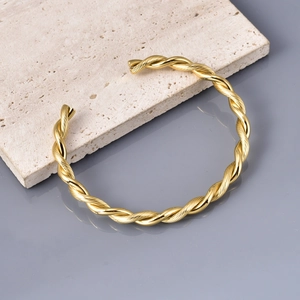 Minimalist gold twisted cable open bangle bracelet with brushed stainless steel finish
