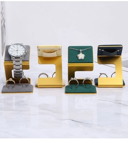 Jewelry display stands in gold metal with gray beige green and blue velvet cushions
