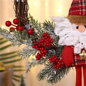 Detailed view of a Santa Claus doll with red plaid fabric on a rustic wicker wreath