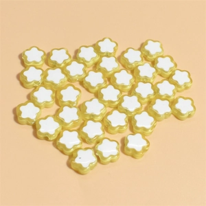 Flat lay of 10mm flower-shaped acrylic beads in light yellow for DIY jewelry making