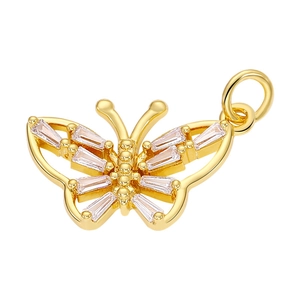 Detail of a golden butterfly charm with rectangular zircon inlays and integrated ring
