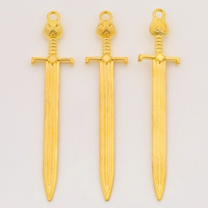 Three gold owl-hilted sword pendants with vertical grooves for DIY jewelry making