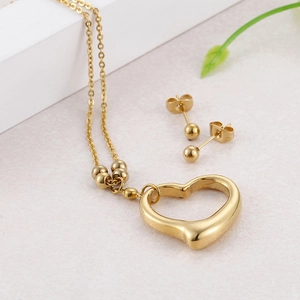 Golden titanium steel jewelry set with hollow heart pendant necklace and ball earrings