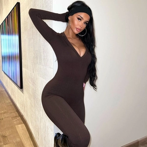 Detail of slim-fit brown ribbed jumpsuit showing textured fabric and V-neckline design
