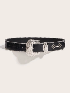 Detail of black crocodile texture leather belt with silver carved buckle and metal rivets