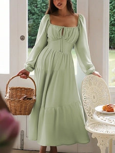 Detail of sage green tiered maxi dress with square neck and puffed sleeves texture