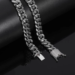 Detailed macro view of 12mm silver Cuban link chain with diamond encrusted clasp