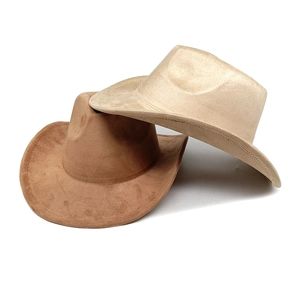 Detail shot of light brown and brown suede cowboy hats with matte texture on white background