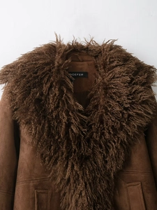 Close-up of brown suede jacket with plush faux fur collar and premium texture details