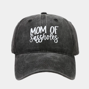Macro view of washed charcoal cotton baseball cap with white MOM OF sassholes lettering